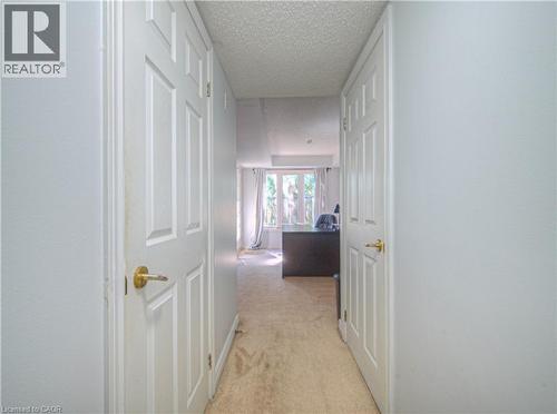 Corridor featuring light colored carpet and a textured ceiling - 310 Christopher Drive Unit# 15, Cambridge, ON - Indoor Photo Showing Other Room