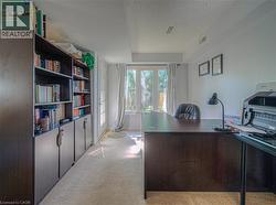 Office space with light carpet and a textured ceiling - 