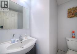 Half bathroom featuring toilet and a sink - 