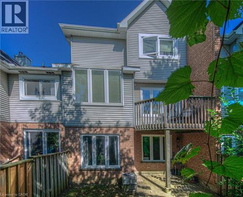 Back of property with a balcony, brick siding, and a patio area - 310 Christopher Drive Unit# 15, Cambridge, ON - Outdoor