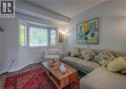 Living room featuring a textured ceiling and wood finished floors - 310 Christopher Drive Unit# 15, Cambridge, ON - Indoor Photo Showing Living Room