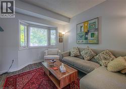 Living room featuring a textured ceiling and wood finished floors - 