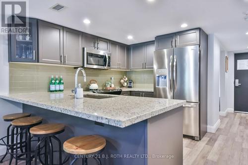 Stainless steel appliances & quartz counters. - 406 - 80 Horseshoe Boulevard, Oro-Medonte, ON - Indoor Photo Showing Kitchen With Stainless Steel Kitchen With Upgraded Kitchen