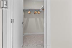 First walk-in closet in primary bedroom - 
