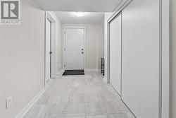 Mudroom with closet and garage access in basement. - 