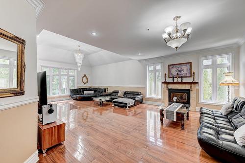Salle familiale - 136 Rue Jean-De Ronceray, Carignan, QC - Indoor Photo Showing Living Room With Fireplace