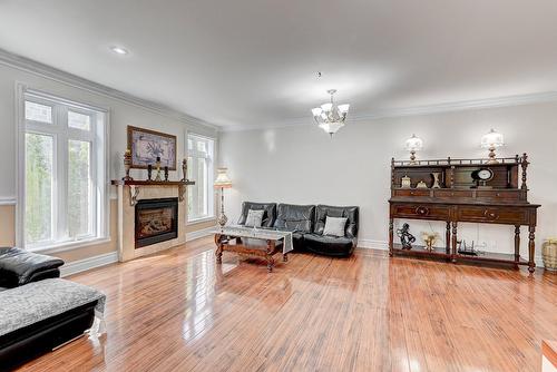 Salle familiale - 136 Rue Jean-De Ronceray, Carignan, QC - Indoor Photo Showing Living Room With Fireplace