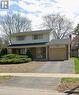 Traditional-style house featuring a garage, a porch, and asphalt driveway - 389 Dunvegan Drive, Waterloo, ON  - Outdoor With Facade 