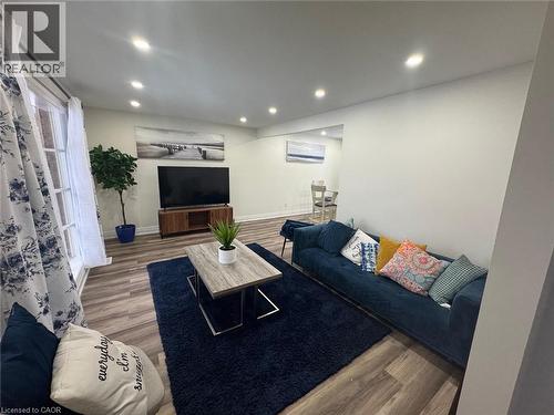 Living room with wood finished floors and recessed lighting - 389 Dunvegan Drive, Waterloo, ON - Indoor