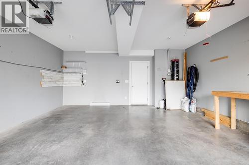 Double Attached Garage - 1818 Peak Point Court Unit# 12, West Kelowna, BC - Indoor Photo Showing Garage