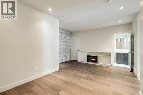 Versatile bonus room on entrance level with full bathroom! - 1818 Peak Point Court Unit# 12, West Kelowna, BC - Indoor With Fireplace