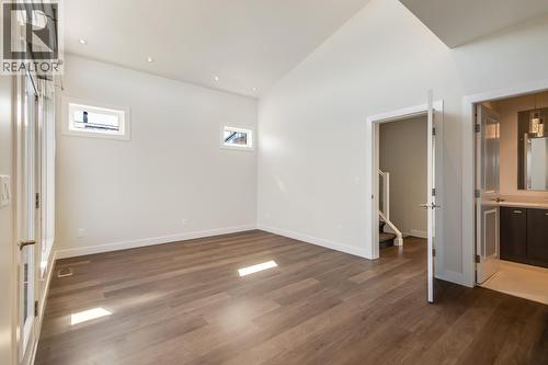 Primary bedroom with ensuite, walk-in closet, and generous patio! - 1818 Peak Point Court Unit# 12, West Kelowna, BC - Indoor Photo Showing Other Room