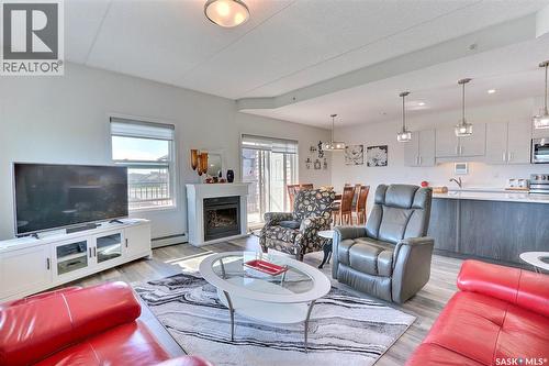 303 2641 Woodbridge Drive, Prince Albert, SK - Indoor Photo Showing Living Room With Fireplace
