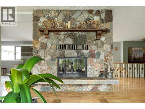 Stunning river rock fireplace - 10108 Venables Drive, Coldstream, BC - Indoor Photo Showing Living Room With Fireplace