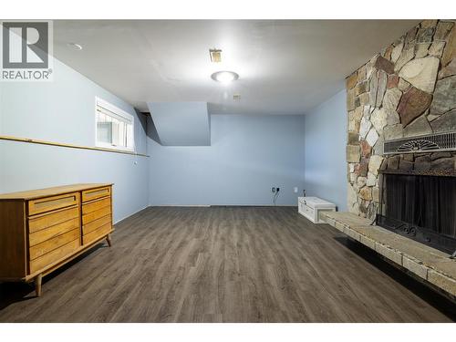 Bedroom #4 is big enough for multiple beds. - 10108 Venables Drive, Coldstream, BC - Indoor Photo Showing Other Room With Fireplace