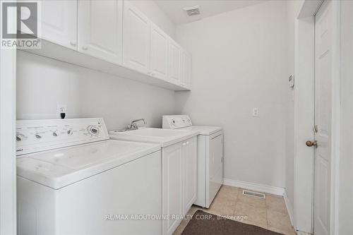 Main floor laundry, access to garage - 2348 Tesla Crescent, Oakville, ON - Indoor Photo Showing Laundry Room