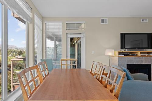301-4205 Gellatly Road, West Kelowna, BC - Indoor Photo Showing Dining Room With Fireplace
