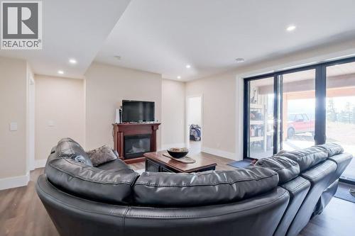 7839 Falcon Ridge Crescent, Kelowna, BC - Indoor Photo Showing Living Room With Fireplace