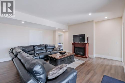 7839 Falcon Ridge Crescent, Kelowna, BC - Indoor Photo Showing Living Room With Fireplace