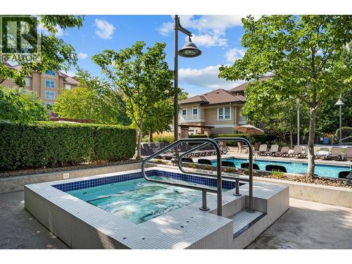 1 of 2 hot tubs - 1075 Sunset Drive Unit# 1404, Kelowna, BC - Outdoor With In Ground Pool