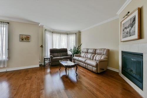 Living room - 2-65 Rue Du Sanctuaire, Sainte-Julie, QC - Indoor Photo Showing Living Room With Fireplace