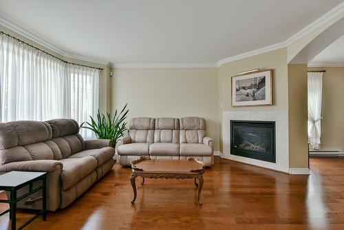 Living room - 2-65 Rue Du Sanctuaire, Sainte-Julie, QC - Indoor Photo Showing Living Room With Fireplace