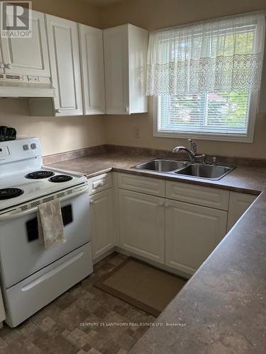 Kitchen with window by sink - 10 Reynolds Place W, Prince Edward County (Wellington Ward), ON - Indoor Photo Showing Kitchen With Double Sink
