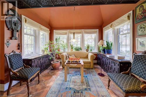 Sunroom featuring radiator heating unit, tile patterned flooring, and an ornate ceiling - 85 Union Boulevard, Kitchener, ON - Indoor