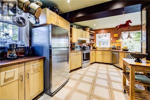 Kitchen with light brown cabinetry, stainless steel appliances, light floors, open shelves, and under cabinet range hood - 85 Union Boulevard, Kitchener, ON - Indoor Photo Showing Kitchen