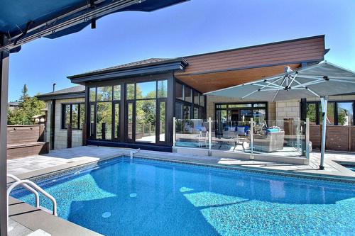 Back facade - 101 Rue Des Cormorans, Val-D'Or, QC - Outdoor With In Ground Pool