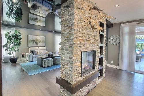 Overall view - 101 Rue Des Cormorans, Val-D'Or, QC - Indoor Photo Showing Living Room With Fireplace