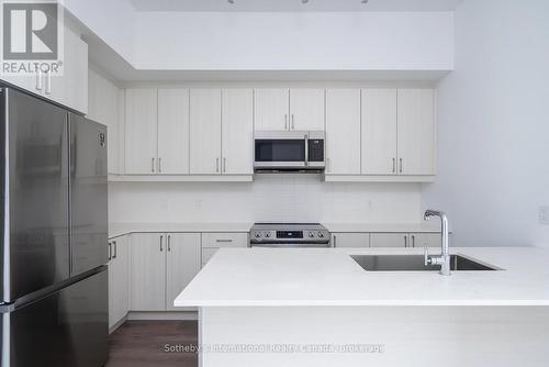 Quartz, Stainless Steel appliances & Breakfast bar - 301 - 1 Hume Street, Collingwood, ON - Indoor Photo Showing Kitchen