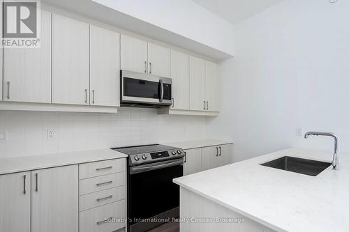 Quartz, Stainless Steel appliances & Breakfast bar - 301 - 1 Hume Street, Collingwood, ON - Indoor Photo Showing Kitchen