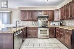 Kitchen with Stainless Steel Slide-In Range - 