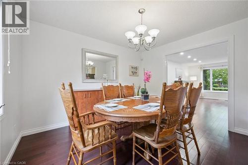 Dining space with a chandelier and dark wood-style flooring - 599 Beechwood Drive, Waterloo, ON - Indoor Photo Showing Dining Room