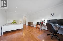 Office area with crown molding, light wood finished floors, and recessed lighting - 