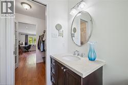 Bathroom featuring vanity and dark wood finished floors - 