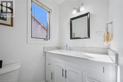 Half bath featuring toilet and vanity - 