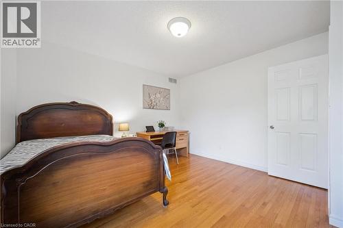 Bedroom with light wood-style flooring, an office area, and a textured ceiling - 599 Beechwood Drive, Waterloo, ON - Indoor Photo Showing Bedroom