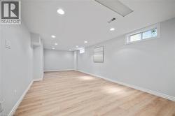 Basement featuring light wood-type flooring and recessed lighting - 