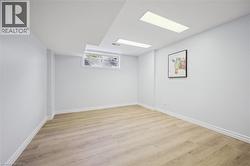 Spare room with light wood-style flooring and baseboards - 