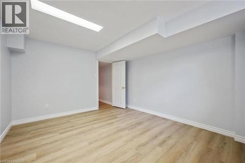 Empty room featuring baseboards and light wood-style flooring - 599 Beechwood Drive, Waterloo, ON - Indoor Photo Showing Other Room
