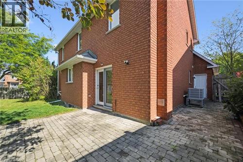 Back of house featuring a patio area, brick siding, and a chimney - 599 Beechwood Drive, Waterloo, ON - Outdoor With Exterior