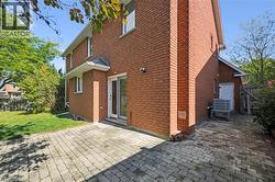 Back of house featuring a patio area, brick siding, and a chimney - 