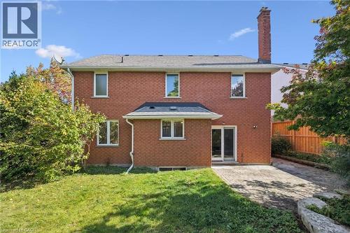 Rear view of property featuring a patio, a chimney, and brick siding - 599 Beechwood Drive, Waterloo, ON - Outdoor With Exterior