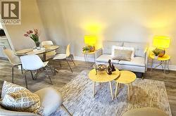 Sitting room featuring baseboards and wood finished floors - 