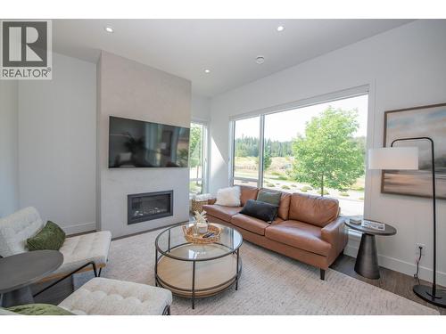 Fully furnished - 105 Predator Ridge Drive Unit# 4, Vernon, BC - Indoor Photo Showing Living Room With Fireplace