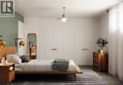 Bedroom with multiple closets and wood finished floors - 