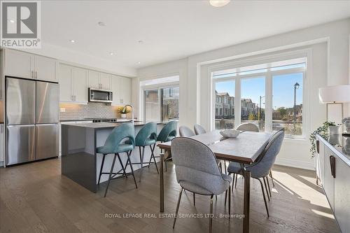 Modern kitchen with extended white cabinetry - 2180 Postmaster Drive, Oakville, ON - Indoor Photo Showing Other Room