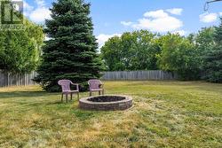 fire pit in fenced back yard - 